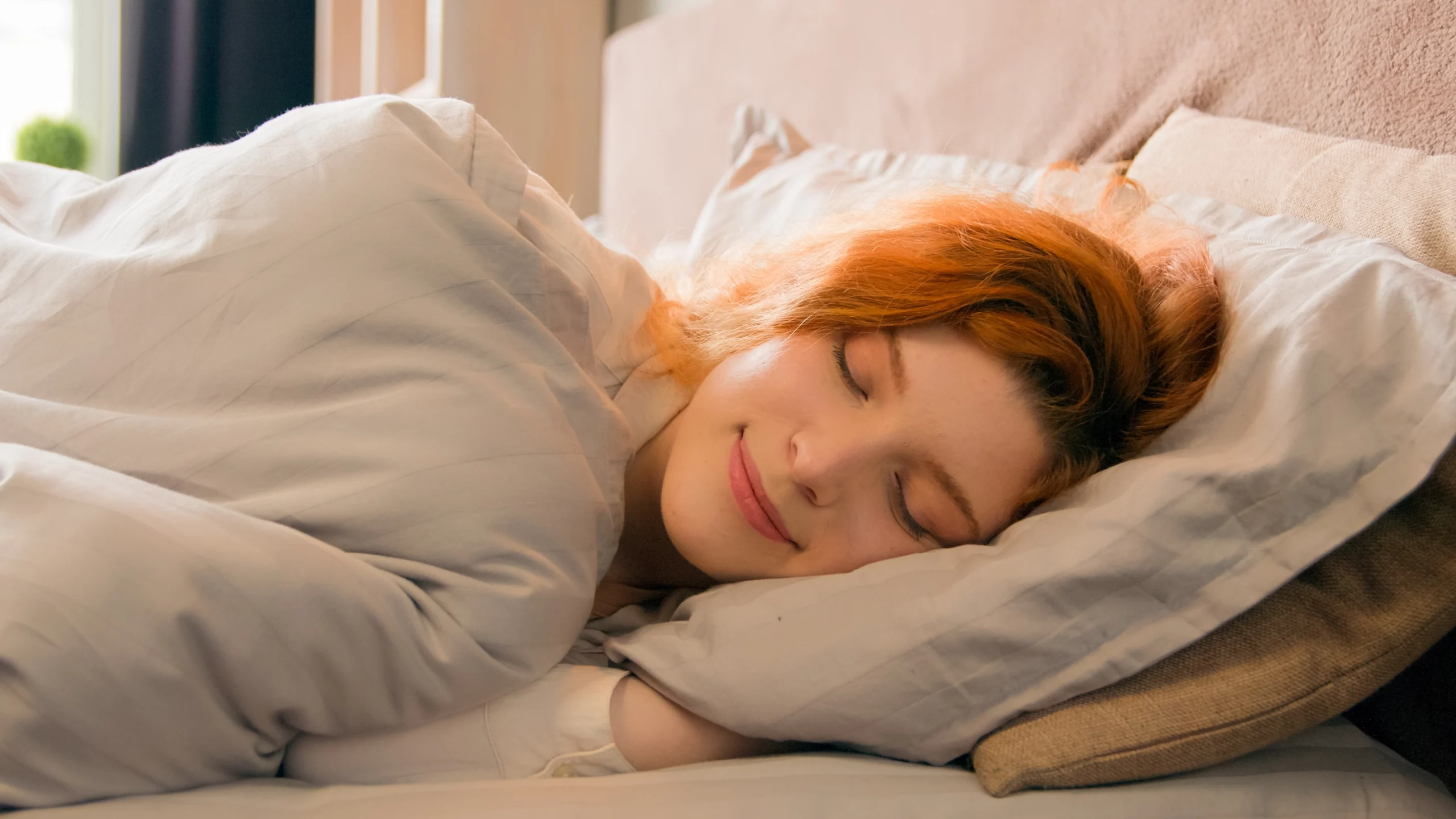 best strains for sleep - redhead woman sleeping in bed